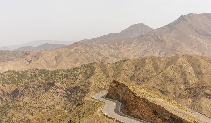 Winding road traversing the rugged Atlas Mountains in Marrakech, Morocco.