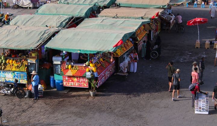 Colorful Moroccan souk stalls in Marrakech bustling with local vendors and fresh produce.