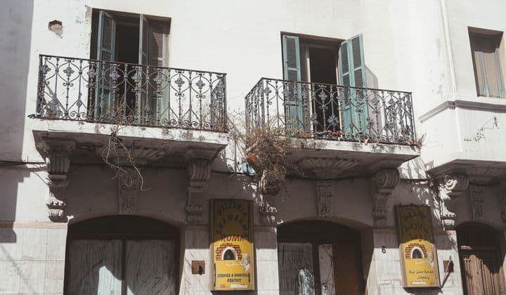 Historic building facade with wrought iron balconies in Tétouan, Morocco.