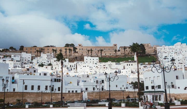 Vibrant cityscape of Tetouan's white medina under a blue sky, perfect for travel inspiration.