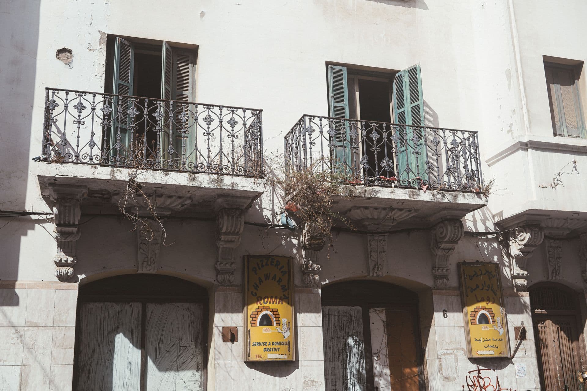 Historic building facade with wrought iron balconies in Tétouan, Morocco.