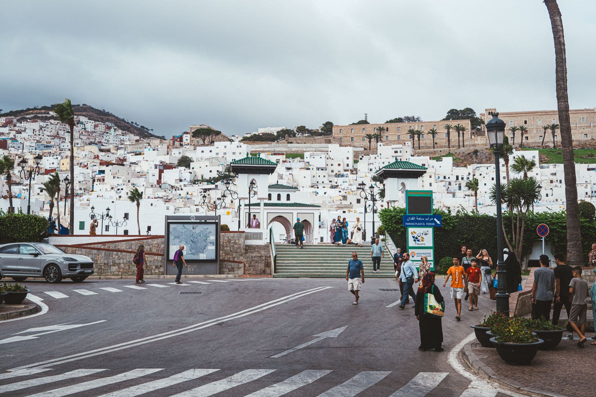 Bustling street in Tétouan with traditional Moroccan architecture and lively atmosphere.