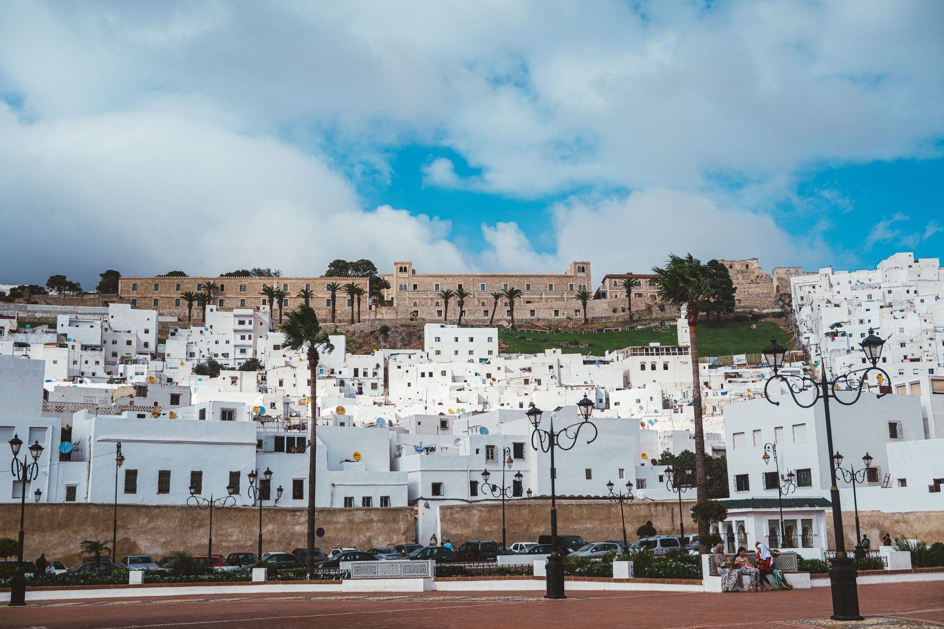 Vibrant cityscape of Tetouan's white medina under a blue sky, perfect for travel inspiration.